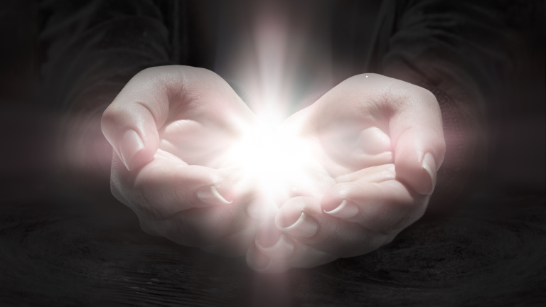 Hands cupping a soft glowing light, representing the precious and fragile gift of life - jillbosman.com